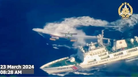 In this image made from video provided by the Armed Forces of the Philippines, a Chinese coast guard ship uses water cannon on a Philippine resupply vessel Unaizah May 4 as it approaches Second Thomas Shoal, locally called Ayungin shoal, at the disputed South China Sea 