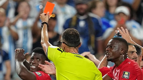 Referee Joao Pinheiro, of Portugal, gives a red card to Switzerland's Breel Embolo (7), left, during the World Cup quarterfinal soccer match between Argentina and
Switzerland in Kansas City