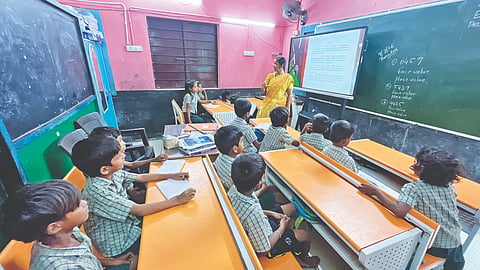 A teacher taking class for primary class students at Chennai Middle School in Sadayankuppam near Manali
