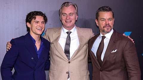Filmmaker Christopher Nolan, centre, with actors Tom Holland, left, and Matt Damon during the premiere of the film
