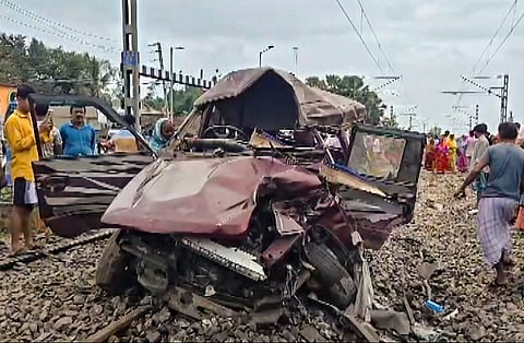 People gather as wreckage of a pool car