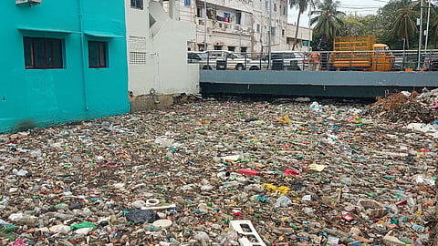 Plastic waste, thermocol, wooden debris, etc, floating in the canal beneath the Tamilar Street bridge