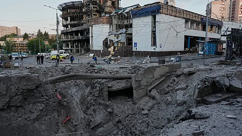 Debris surrounds a missile crater in the foreground of a building following Russia’s missile attack in Kyiv, Ukraine.