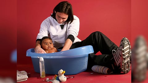 Lionel Messi with baby Lamine Yamal