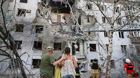 Residents look at their ruined home following a Russian air guided bomb strike in Zaporizhzhia, Ukraine.