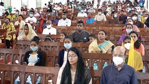 Devotees praying at mass in the church.