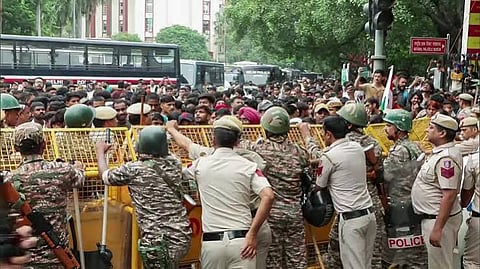 Security personnel stop Cockroach Janta Party (CJP) protesters during a protest march against the alleged NEET paper leak from Jantar Mantar to Parliament House, in New Delhi 