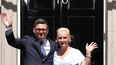 Britain’s new Prime Minister Andy Burnham and his wife Marie-France van Heel wave as they arrive at 10 Downing Street in London