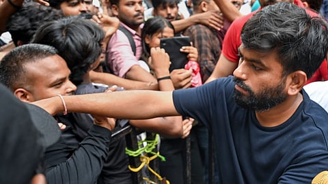 Cockroach Janata Party (CJP) founder Abhijeet Dipke meets supporters during the protest demanding the resignation of Union Education Minister Dharmendra Pradhan over alleged irregularities in the NEET examination, a day after clash erupted during the 'Sansad Chalo' march, at Jantar Mantar, in New Delhi, Tuesday, July 21, 2026
