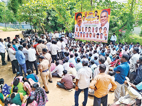 Paddy procurement staff staging a protest in Thanjavur on Tuesday