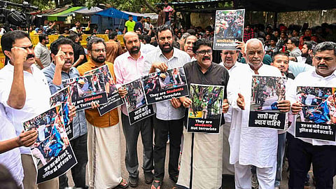 CPI (M) MP John Brittas and others raise slogans as they visit Jantar Mantar during a protest by Cockroach Janata Party founder (CJP) demanding the resignation of Union Education Minister Dharmendra Pradhan over alleged irregularities in the NEET examination, a day after police action on students during the 'Sansad Chalo' march, in New Delhi, Tuesday, July 21, 2026