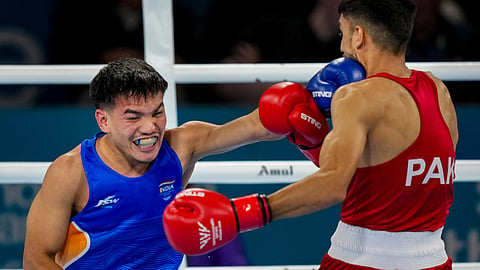 India's Jadumani Singh Mandengbam, blue, competes against Pakistan's Sumama Rehman during the men's 55kg boxing round of 16 at the 23rd Commonwealth Games, in Glasgow.