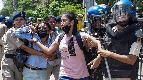 Police personnel detains a demonstrator during Bihar bandh call by AISA and other student organisations in the state, demanding the resignation of Union Education Minister Dharmendra Pradhan over the NEET paper leak issue