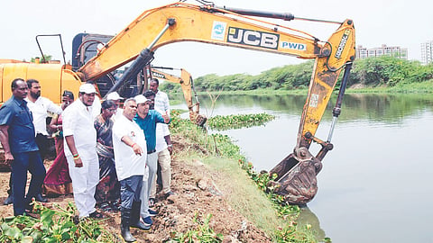 Minister N Anand reviewing the work while launching the desilting of Adyar river on Tuesday