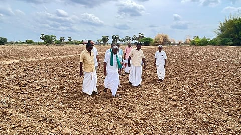 Farmers inspect a parched paddy field at Azhiyur in Nagapattinam on Wednesday