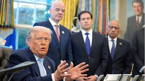President Donald Trump answers questions from reporters during a meeting with the White House task force on the 2026 FIFA World Cup in the Oval Office of the White House, Monday, Nov. 17, 2025, in Washington, as FIFA President Gianni Infantino, Secretary of State Marco Rubio and FIFA senior adviser Carlos Cordeiro listen.