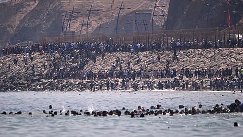 Migrants cross from Morocco into the Spanish enclave of Ceuta.