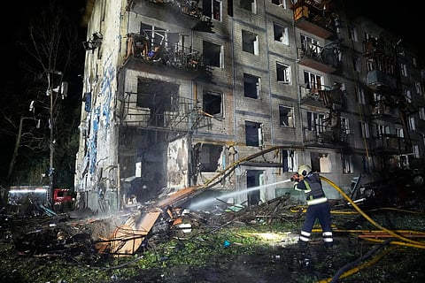 Emergency services personnel work to extinguish a fire following Russian missile attacks in Kyiv, Ukraine, Saturday, Aug. 1, 2026