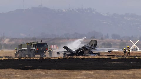 Crews extinguish an F-35 fighter jet that crashed near the runway at Marine Corps Air Station Miramar in San Diego, Calif.