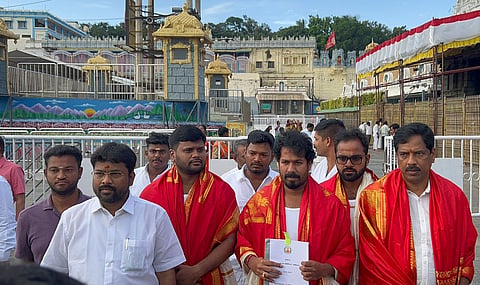 Agriculture and Farmers' Welfare Minister R Vinoth with a budget-related document at Tirumala Venkateswara Temple in Tirupati