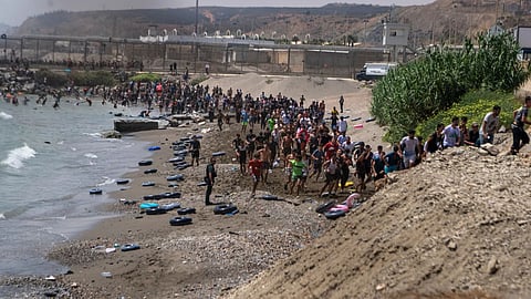 Migrants cross from Morocco into the Spanish enclave of Ceuta