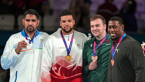 From left, Silver medallist India's Narender, gold medallist England's Damar Thomas and bronze medallists Ireland's William John McCartan and Trinidad and Tobago's Nigel Paul during the presentation ceremony after the men's 90+kg final boxing event at the 23rd Commonwealth Games (CWG), in Glasgow, Scotland, Saturday