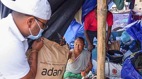 Volunteers carry relief kits to flood-affected families at a temporary shelter, in Upper Assam. The relief drive aims to provide essential supplies to families affected by floods in Sivasagar and Dhemaji districts.