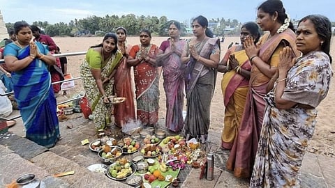 People performing rituals at Amma Mandapam bathing ghat, where the backdrop shows a parched Cauvery, on Monday (August 3).