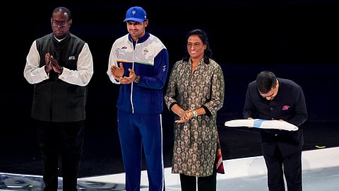 Gujarat Deputy Chief Minister Harsh Sanghavi, right, after receiving the Commonwealth Games Federation flag from Commonwealth Sport President Donald Rukare, left, during the closing ceremony of the 23rd Commonwealth Games (CWG), at OVO Hydro