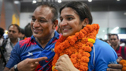 Gold medallist Arundhati Choudhary, right, being welcomed on her arrival after the Glasgow Commonwealth Games, at IGI Airport in New Delhi.