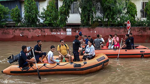 SDRF personnel rescue people from a water logged area following rainfall, at Rukmini Gaon