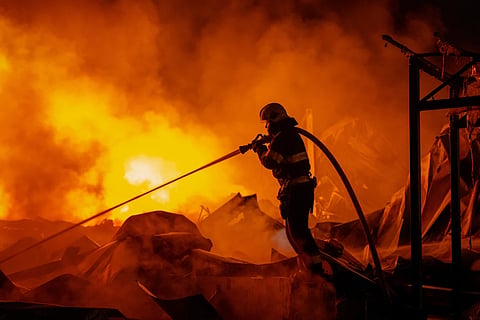 Firefighters put out a fire after Russian missiles hit a warehouse in Kyiv, Ukraine, Wednesday, Aug. 5, 2026