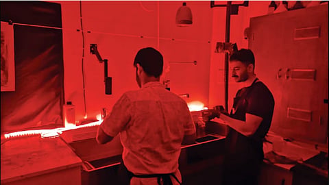 People working on a silver gelatin prints from darkroom 102 workshop