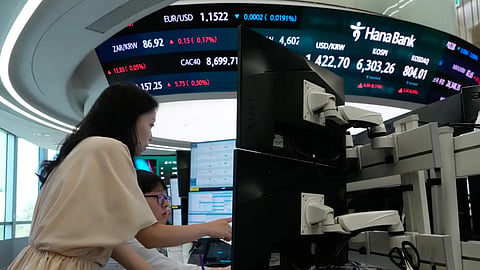 Currency traders watch monitors at the foreign exchange dealing room of the Hana Bank headquarters in Seoul, South Korea, Friday, Aug. 7, 2026