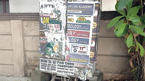 Posters pasted over an electricity distribution box on Anna Nagar 13th Main Road coming off
