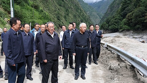 Chinese Premier Li Qiang, fifth from left, inspects a mudslide-hit area in Gyirong County in Xigaze, southwestern China's Tibet Autonomous Region