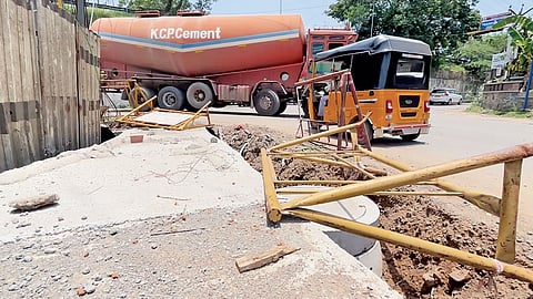 Fallen barricades along the portion of Tambaram-Somangalam road dug for SWD works
