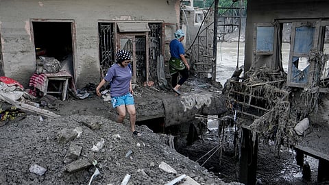 Sonu Adhikari looks for remains at her house that was destroyed in the devastating flash floods at Galchhi area, in Dhading district of Central Nepal