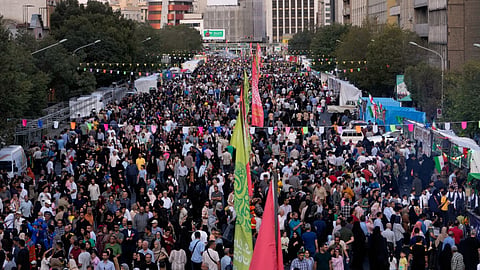 Crowds fill a street during celebrations marking Prophet Muhammad's birthday in Tehran, Iran