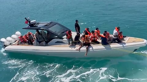 Rescued passengers wearing life jackets are evacuated by boat after a passenger vessel capsized off the coast of Girne, in the Turkish-occupied northern part of Cyprus