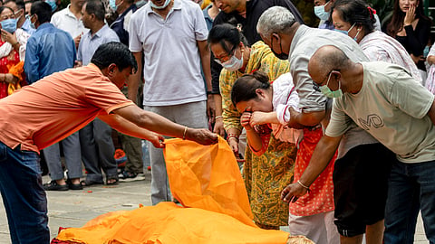 Rubina Maharjan breaks down while performing the final rituals for her sister-in-law, 41-year-old Sundari Shrestha, who lost her life in a catastrophic flash flood, in Kathmandu