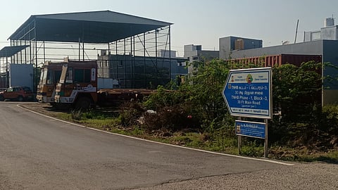 Container lorries and empty trucks parked on vacant sites at Manali New Town