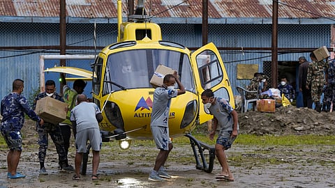 Nepal army officials transport fuel containers and relief material during a rescue operation after the devastating flash floods