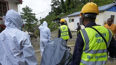 Rescue personnel, including Nepal Police officers, carry the body of a flood victim recovered from the flood-affected area, in Rasuwa district, Nepal. Search and rescue operations remain underway following devastating flash floods in the region.
