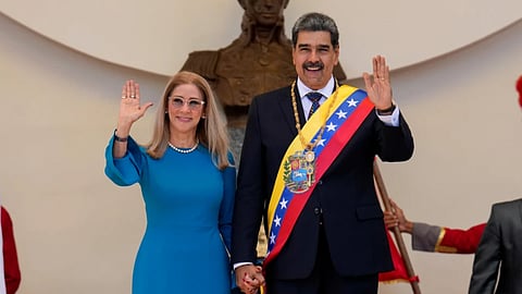 Venezuelan President Nicolas Maduro and his wife Cilia Flores wave after his swearing-in ceremony for a third term at the National Assembly in Caracas, Venezuela