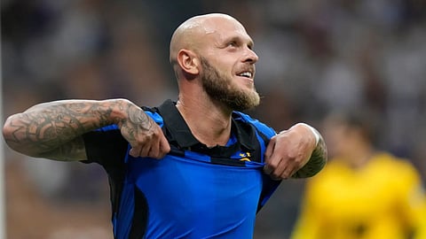 Inter Milan's Federico Dimarco celebrates at the end of a Serie A soccer match between Inter Milan and Monza, in Milan, Italy.