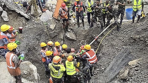 Nepal army personnel and other officials rescue a man from the tunnel of the Trishuli 3A Hydropower Project, in the aftermath of the recent flash floods in Nepal