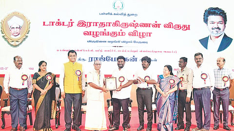 Minister A Rajmohan and education department officials conferring Dr Radhakrishnan Award to a teacher on Saturday (September 5) in Chennai.