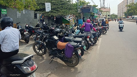 Bikes parked at the  footpath near the Megamart bus stop in Arumbakkam, Chennai.