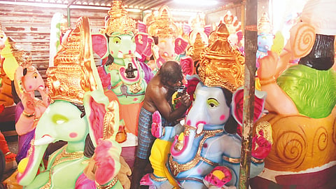 Artisans work on idols at a unit in Mela Kondayampettai